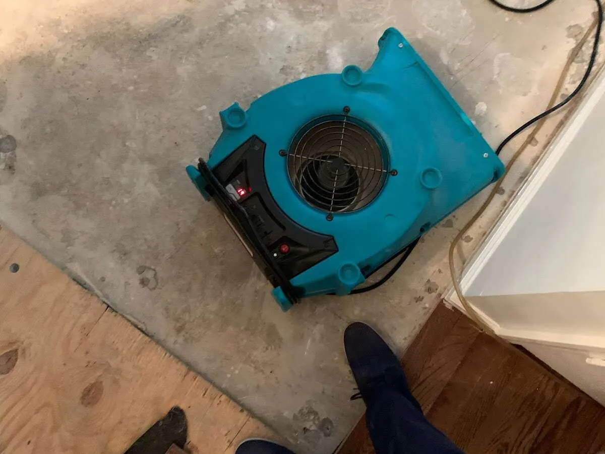 Air mover drying subfloor during Commercial Water Damage Restoration in Streamwood